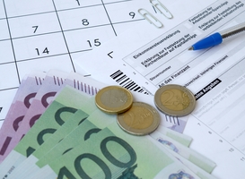 Normal_german-tax-form-with-pen-and-european-money-bills-2023-11-27-05-23-57-utc