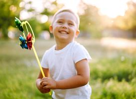 Normal_smiling-child-with-toy-in-summer-park-on-sunny-day-2023-11-27-05-05-44-utc