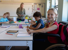 Normal_schoolgirl-sitting-in-a-wheelchair-in-an-elementar-2023-11-27-05-14-43-utc