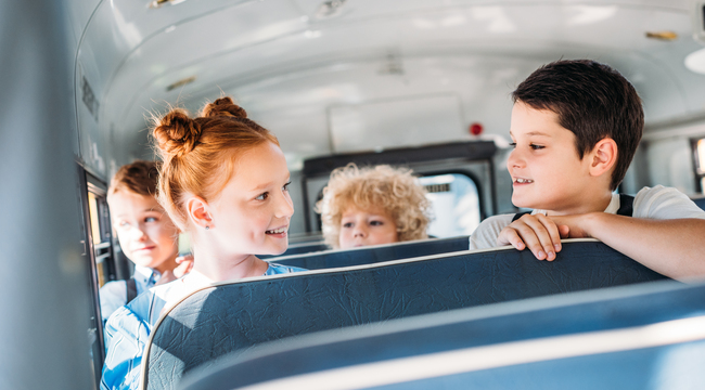 Carousel_group-of-happy-little-pupils-riding-on-school-bus-2023-11-27-05-08-41-utc
