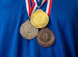 Normal_gold-silver-and-bronze-medals-set-on-blue-shirt-b-2023-11-27-05-26-23-utc