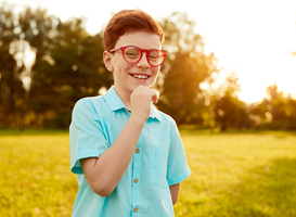 Normal_happy-kid-in-glasses-standing-on-green-meadow-2023-11-27-05-32-37-utc