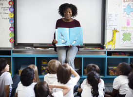 Normal_kindergarten-students-sitting-on-the-floor-listeni-2023-11-27-05-26-53-utc