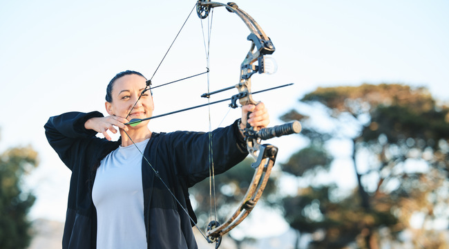 Carousel_happy-woman-bow-or-arrows-aim-in-sports-field-sh-2023-11-27-05-10-45-utc