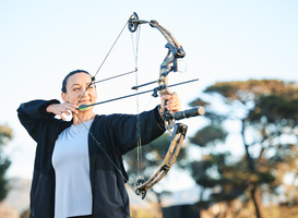 Normal_happy-woman-bow-or-arrows-aim-in-sports-field-sh-2023-11-27-05-10-45-utc