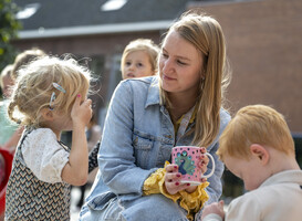 Normal_a-young-woman-smiling-at-a-child-while-other-child-2024-03-01-16-42-27-utc