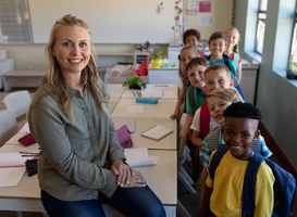 Normal_female-school-teacher-sitting-on-a-desk-in-a-class-2023-11-27-05-23-59-utc